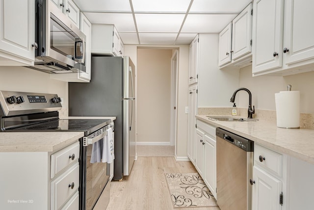 2 S Atrium Way Unit 407, Elmhurst, IL 60126 - kitchen with stainless steel appliances, a sink, light wood-style flooring, white cabinetry, and a paneled ceiling