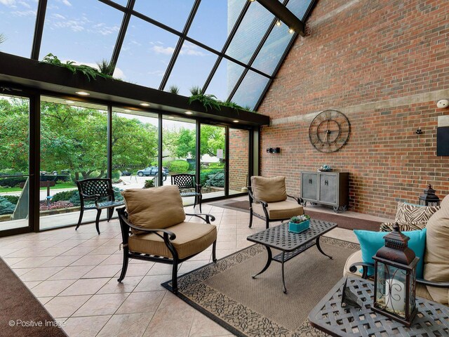 2 S Atrium Way Unit 407, Elmhurst, IL 60126 - tiled living area with a towering ceiling and brick wall