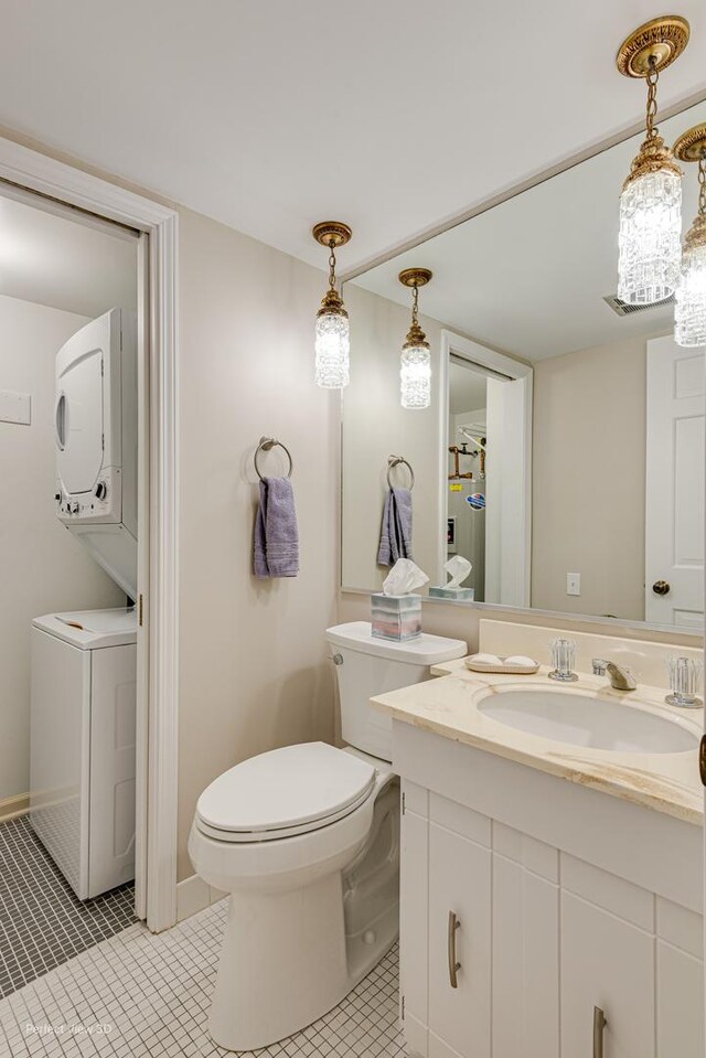 2 S Atrium Way Unit 407, Elmhurst, IL 60126 - bathroom with stacked washer / drying machine, tile patterned flooring, toilet, and vanity