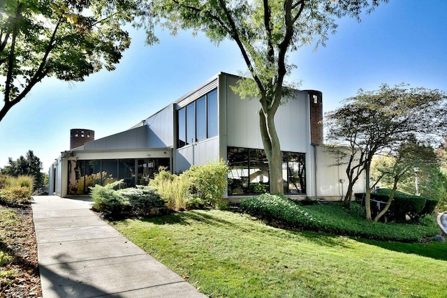 2 S Atrium Way Unit 407, Elmhurst, IL 60126 - view of front of property with a front lawn and a chimney