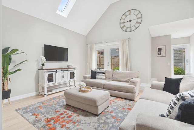 2534 W Haddon Ave, Chicago, IL 60622 - living room featuring high vaulted ceiling, a skylight, wood finished floors, baseboards, and french doors