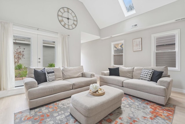 2534 W Haddon Ave, Chicago, IL 60622 - living room featuring a skylight, wood finished floors, high vaulted ceiling, baseboards, and french doors