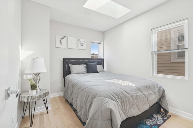 2534 W Haddon Ave, Chicago, IL 60622 - bedroom featuring a skylight, light wood finished floors, and baseboards