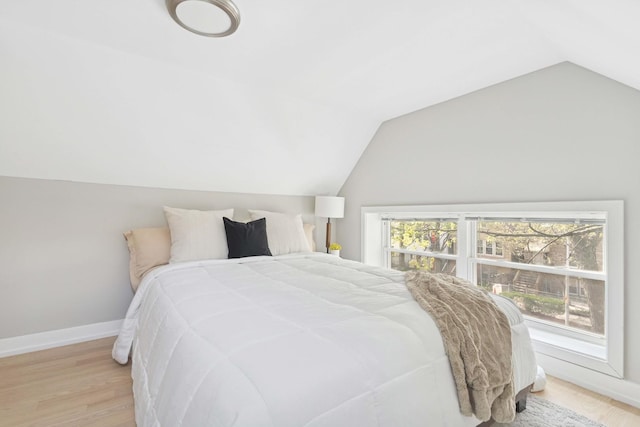 2534 W Haddon Ave, Chicago, IL 60622 - bedroom with lofted ceiling, baseboards, and light wood-style floors