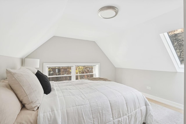2534 W Haddon Ave, Chicago, IL 60622 - bedroom featuring wood finished floors, lofted ceiling, and baseboards