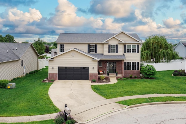 1811 Partridge Pt, Normal, IL 61761 - view of front of home with brick siding, concrete driveway, and an attached garage