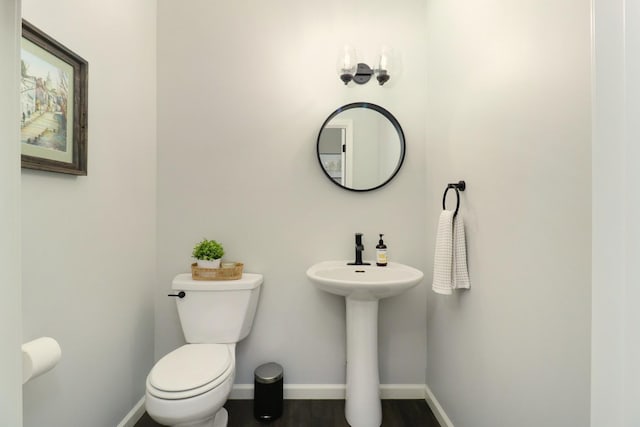 1811 Partridge Pt, Normal, IL 61761 - half bath with toilet, baseboards, wood finished floors, and a sink