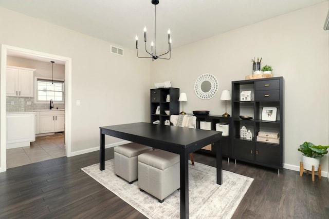 1811 Partridge Pt, Normal, IL 61761 - dining room with a chandelier, dark wood-style floors, and baseboards