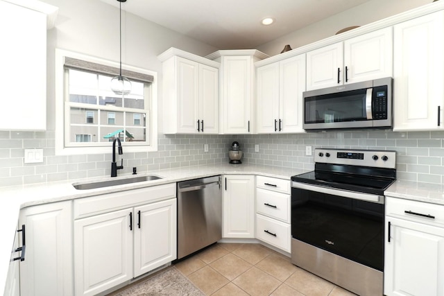 1811 Partridge Pt, Normal, IL 61761 - kitchen featuring stainless steel appliances, a sink, white cabinetry, light countertops, and decorative backsplash