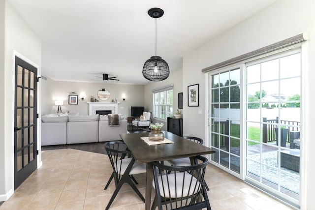 1811 Partridge Pt, Normal, IL 61761 - dining area with light tile patterned floors, a fireplace, and ceiling fan