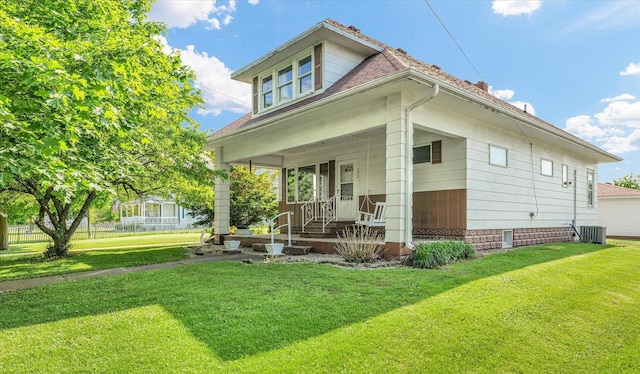 235 N Main St, Roberts, IL 60962 - rear view of house with covered porch, a lawn, and central AC