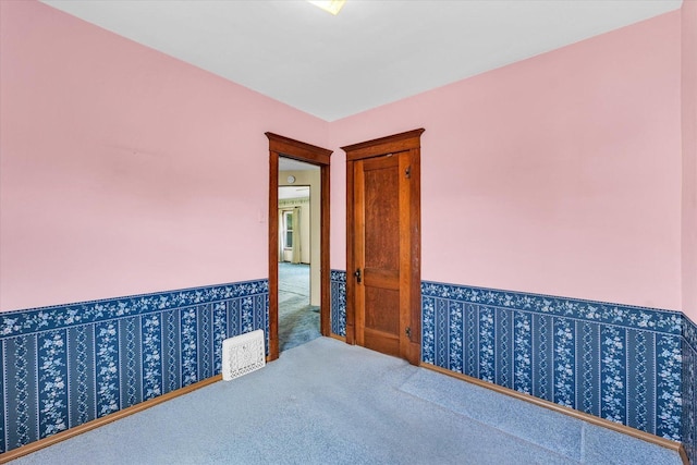 235 N Main St, Roberts, IL 60962 - carpeted empty room featuring wainscoting