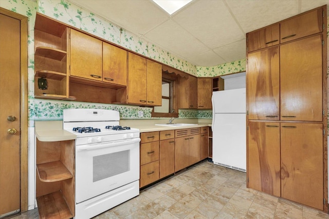 235 N Main St, Roberts, IL 60962 - kitchen featuring open shelves, white appliances, a sink, wallpapered walls, and light countertops
