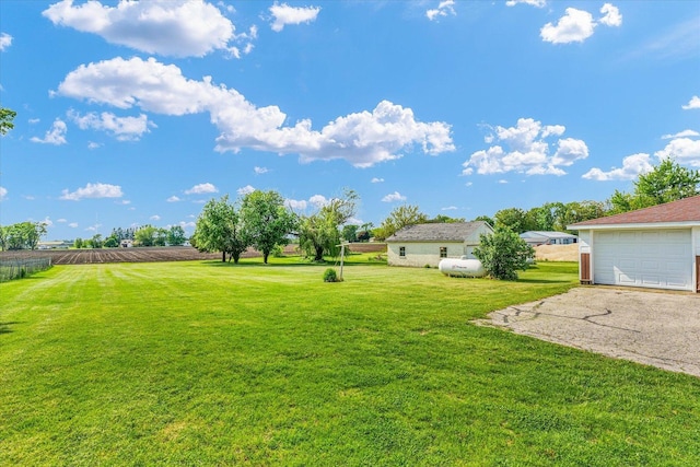 235 N Main St, Roberts, IL 60962 - view of green lawn featuring asphalt driveway and a detached garage