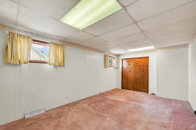 235 N Main St, Roberts, IL 60962 - basement featuring carpet flooring, healthy amount of natural light, a drop ceiling, and wooden walls