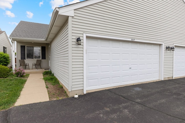 557 Sandy Ct, Harvard, IL 60033 - view of side of home featuring roof with shingles and a garage