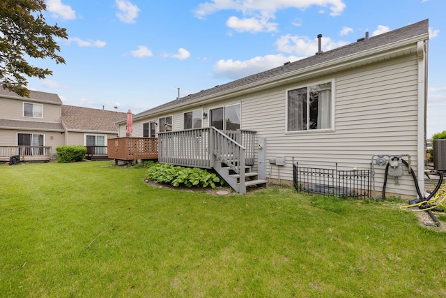 557 Sandy Ct, Harvard, IL 60033 - rear view of house with a deck, a lawn, and cooling unit