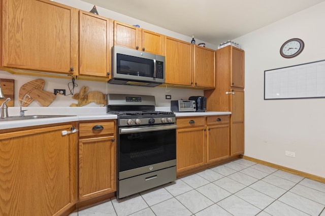 557 Sandy Ct, Harvard, IL 60033 - kitchen featuring appliances with stainless steel finishes, a sink, light countertops, and light tile patterned floors