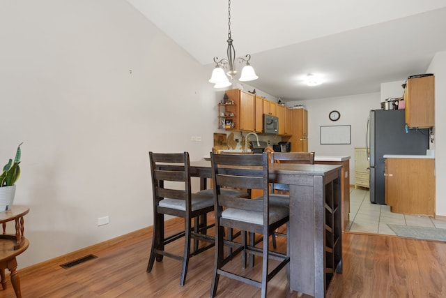 557 Sandy Ct, Harvard, IL 60033 - kitchen with stainless steel appliances, light wood-style flooring, open shelves, and light countertops