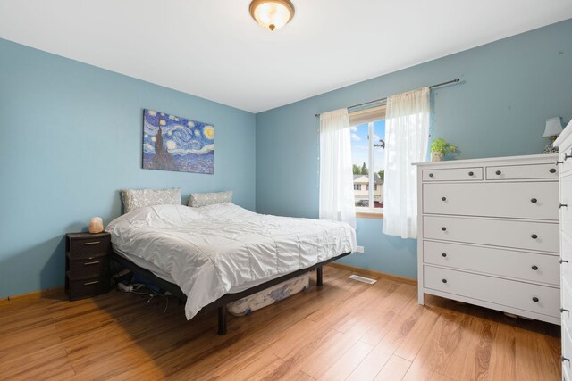 557 Sandy Ct, Harvard, IL 60033 - bedroom with light wood-style flooring and baseboards