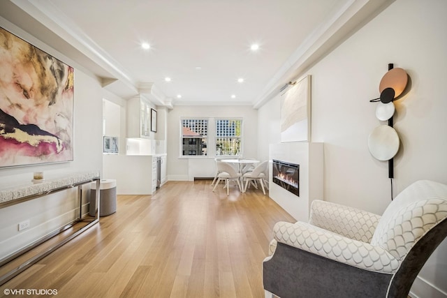 4300 N Marine Dr Unit 306, Chicago, IL 60613 - sitting room featuring light wood-type flooring, a glass covered fireplace, crown molding, recessed lighting, and baseboards
