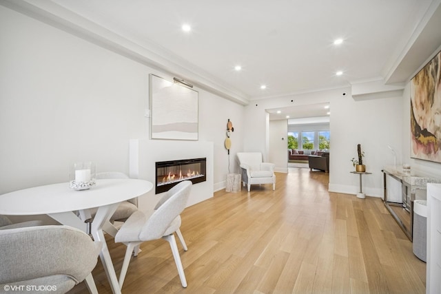 4300 N Marine Dr Unit 306, Chicago, IL 60613 - dining area with a glass covered fireplace, recessed lighting, light wood finished floors, baseboards, and ornamental molding