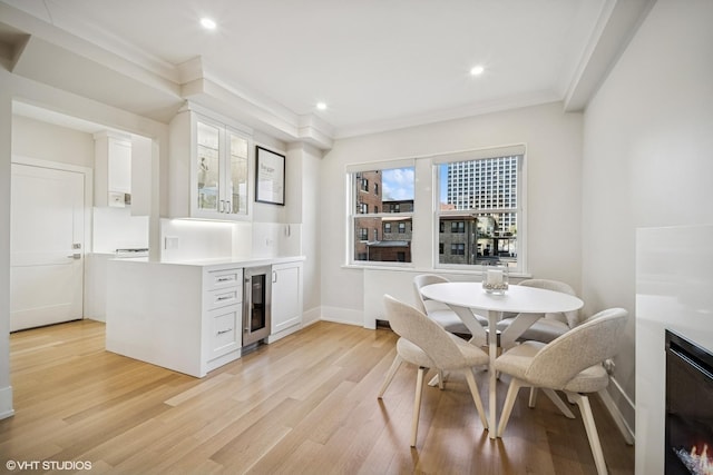 4300 N Marine Dr Unit 306, Chicago, IL 60613 - dining space with beverage cooler, light wood finished floors, ornamental molding, recessed lighting, and baseboards