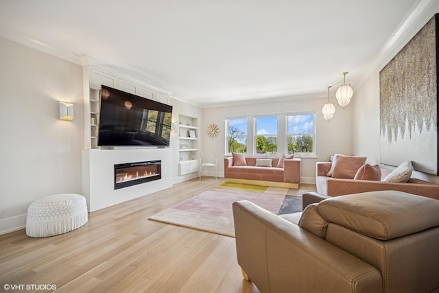 4300 N Marine Dr Unit 306, Chicago, IL 60613 - living room with light wood-style flooring, crown molding, a glass covered fireplace, built in features, and baseboards