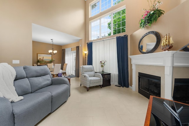 307 Lake Gillilan Way, Algonquin, IL 60102 - living area with a towering ceiling, a chandelier, a glass covered fireplace, and healthy amount of natural light