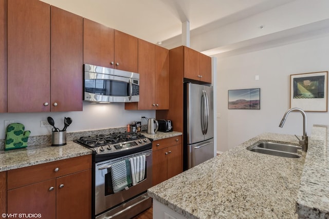 310 S Michigan Ave Unit 2006, Chicago, IL 60604 - kitchen with stainless steel appliances, a sink, light stone countertops, and brown cabinetry