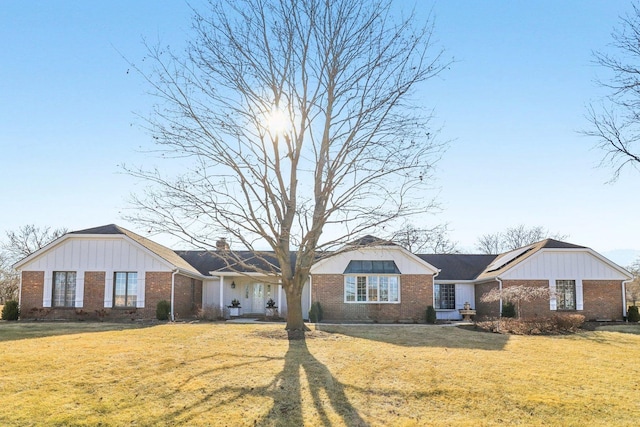 723 Beacon Dr, Lake Barrington, IL 60010 - single story home with brick siding, board and batten siding, a front lawn, and a chimney