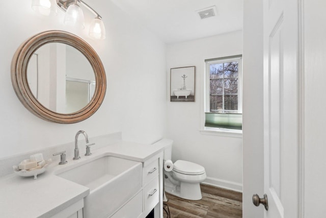 723 Beacon Dr, Lake Barrington, IL 60010 - bathroom with toilet, wood finished floors, vanity, and baseboards