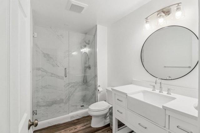 723 Beacon Dr, Lake Barrington, IL 60010 - bathroom with wood finished floors, a marble finish shower, toilet, and vanity