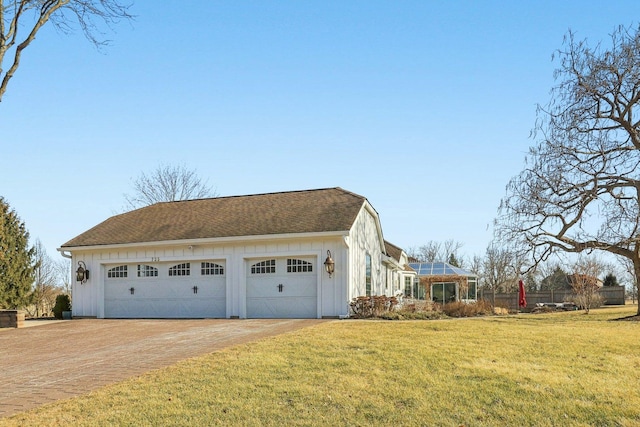 723 Beacon Dr, Lake Barrington, IL 60010 - view of side of property featuring board and batten siding, a garage, and a shingled roof