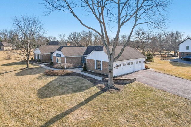 723 Beacon Dr, Lake Barrington, IL 60010 - single story home featuring brick siding, a front yard, asphalt driveway, and an attached garage