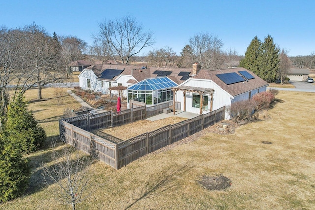 723 Beacon Dr, Lake Barrington, IL 60010 - rear view of property with solar panels, a fenced backyard, and a chimney