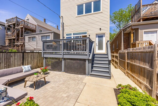 2629 W Homer St, Chicago, IL 60647 - rear view of property featuring a fenced backyard, a patio area, and a deck