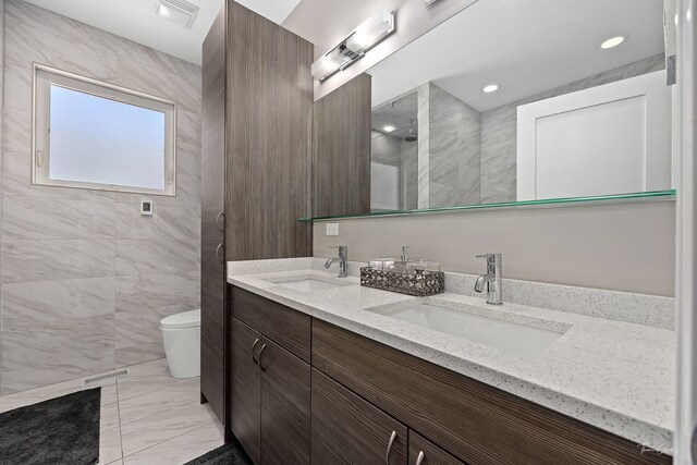 2629 W Homer St, Chicago, IL 60647 - bathroom with double vanity, toilet, tiled shower, and marble finish flooring