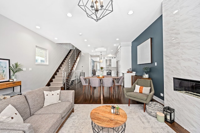 2629 W Homer St, Chicago, IL 60647 - living room featuring wood finished floors, stairway, recessed lighting, a high end fireplace, and a chandelier