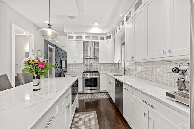 2629 W Homer St, Chicago, IL 60647 - kitchen featuring wall chimney range hood, appliances with stainless steel finishes, a sink, white cabinetry, and dark wood finished floors