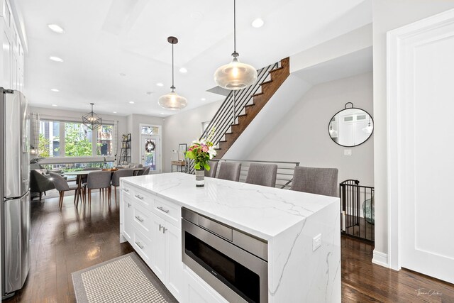 2629 W Homer St, Chicago, IL 60647 - kitchen featuring appliances with stainless steel finishes, recessed lighting, dark wood-type flooring, white cabinets, and decorative light fixtures