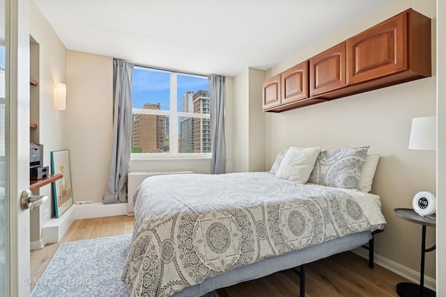 40 E Cedar St Unit 8Cd, Chicago, IL 60611 - bedroom with light wood-type flooring and a view of city