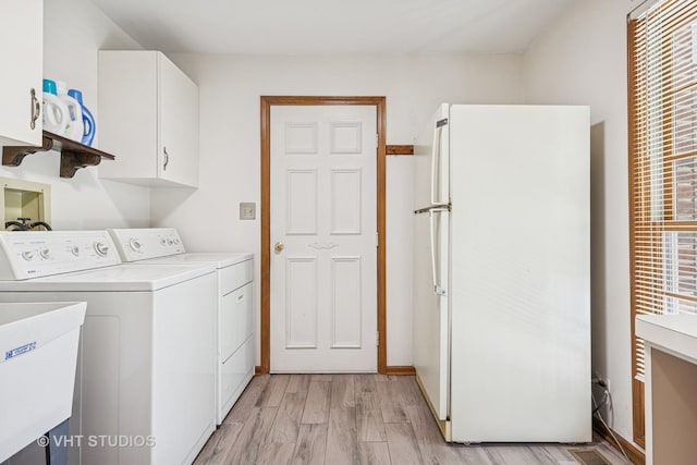5808 Amherst Ct, Mchenry, IL 60050 - laundry room with washing machine and clothes dryer, cabinet space, and light wood-type flooring
