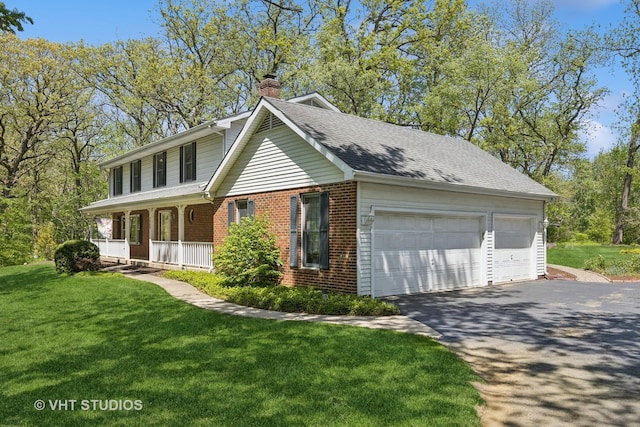 5808 Amherst Ct, Mchenry, IL 60050 - view of front of property featuring a chimney, brick siding, covered porch, a front yard, and driveway