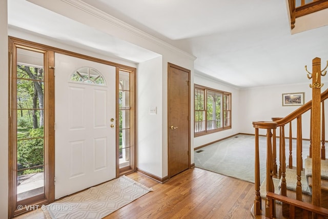 5808 Amherst Ct, Mchenry, IL 60050 - foyer featuring light wood-style floors, plenty of natural light, baseboards, stairway, and crown molding