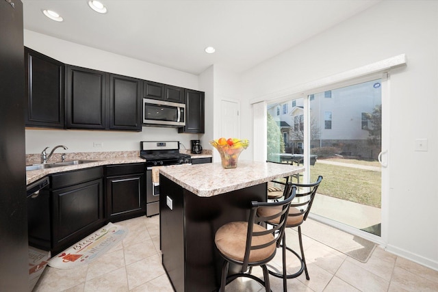 217 Owen St, Matteson, IL 60443 - kitchen featuring appliances with stainless steel finishes, a sink, dark cabinets, light countertops, and recessed lighting