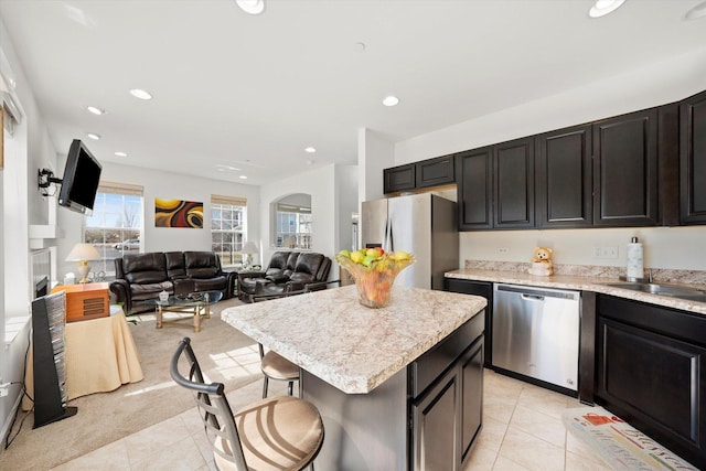217 Owen St, Matteson, IL 60443 - kitchen featuring stainless steel appliances, a center island, light countertops, light tile patterned flooring, and recessed lighting