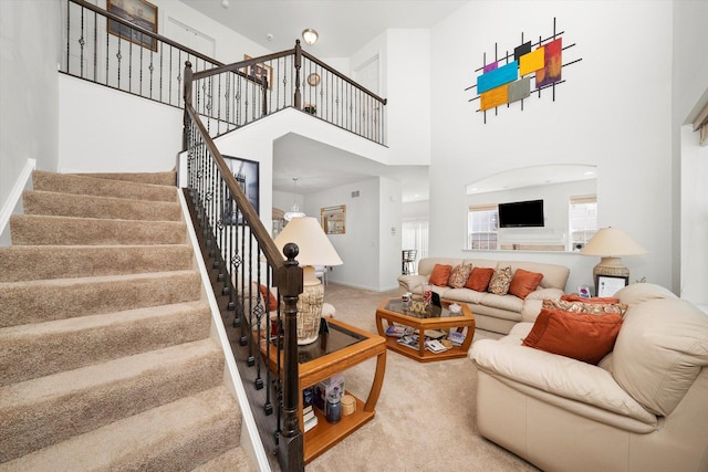 217 Owen St, Matteson, IL 60443 - living area with carpet, stairs, a towering ceiling, and baseboards