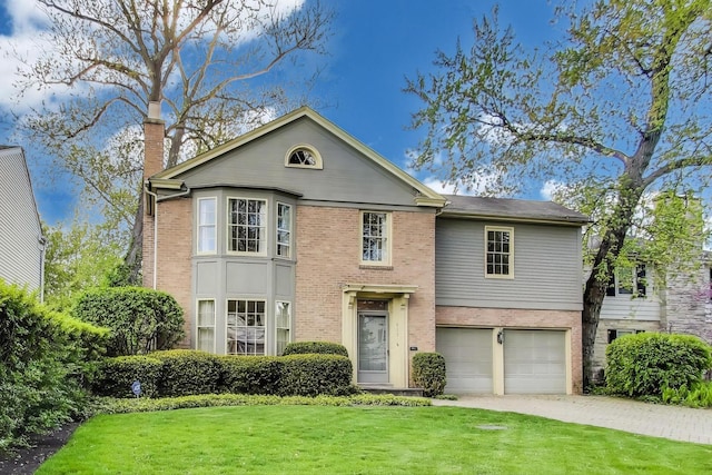 915 Pontiac Rd, Wilmette, IL 60091 - view of front of property featuring a front yard, a garage, a chimney, and brick siding
