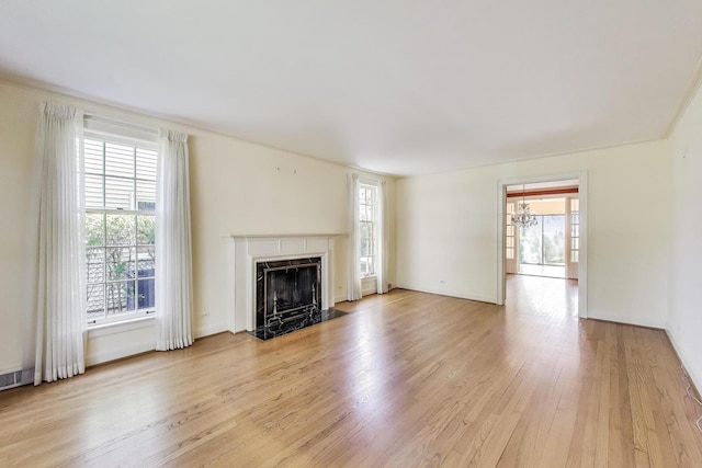 915 Pontiac Rd, Wilmette, IL 60091 - unfurnished living room featuring light wood-style flooring, plenty of natural light, and a fireplace with flush hearth